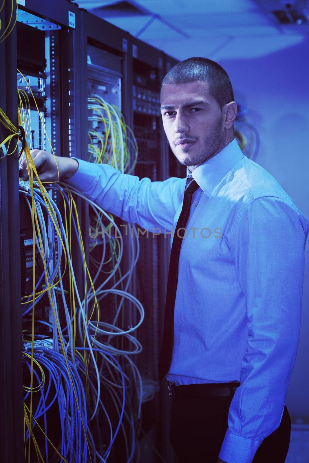 young handsome business man  engeneer in datacenter server room