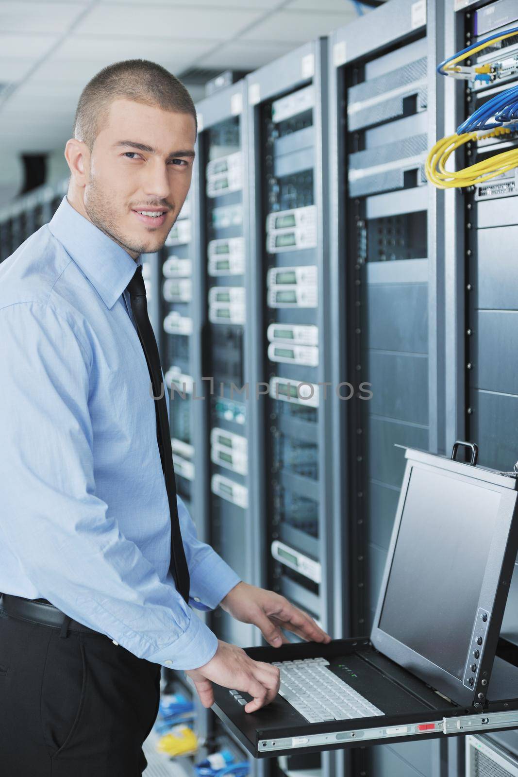 young handsome business man  engeneer in datacenter server room