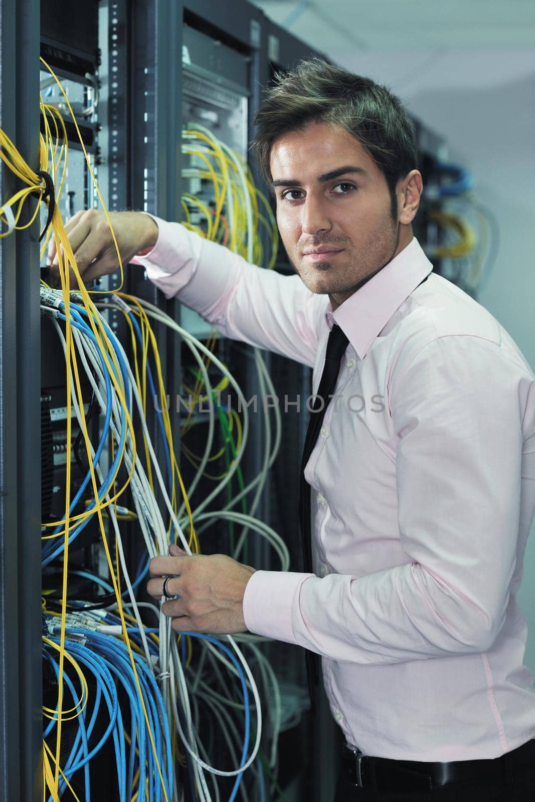 young handsome business man  engeneer in datacenter server room