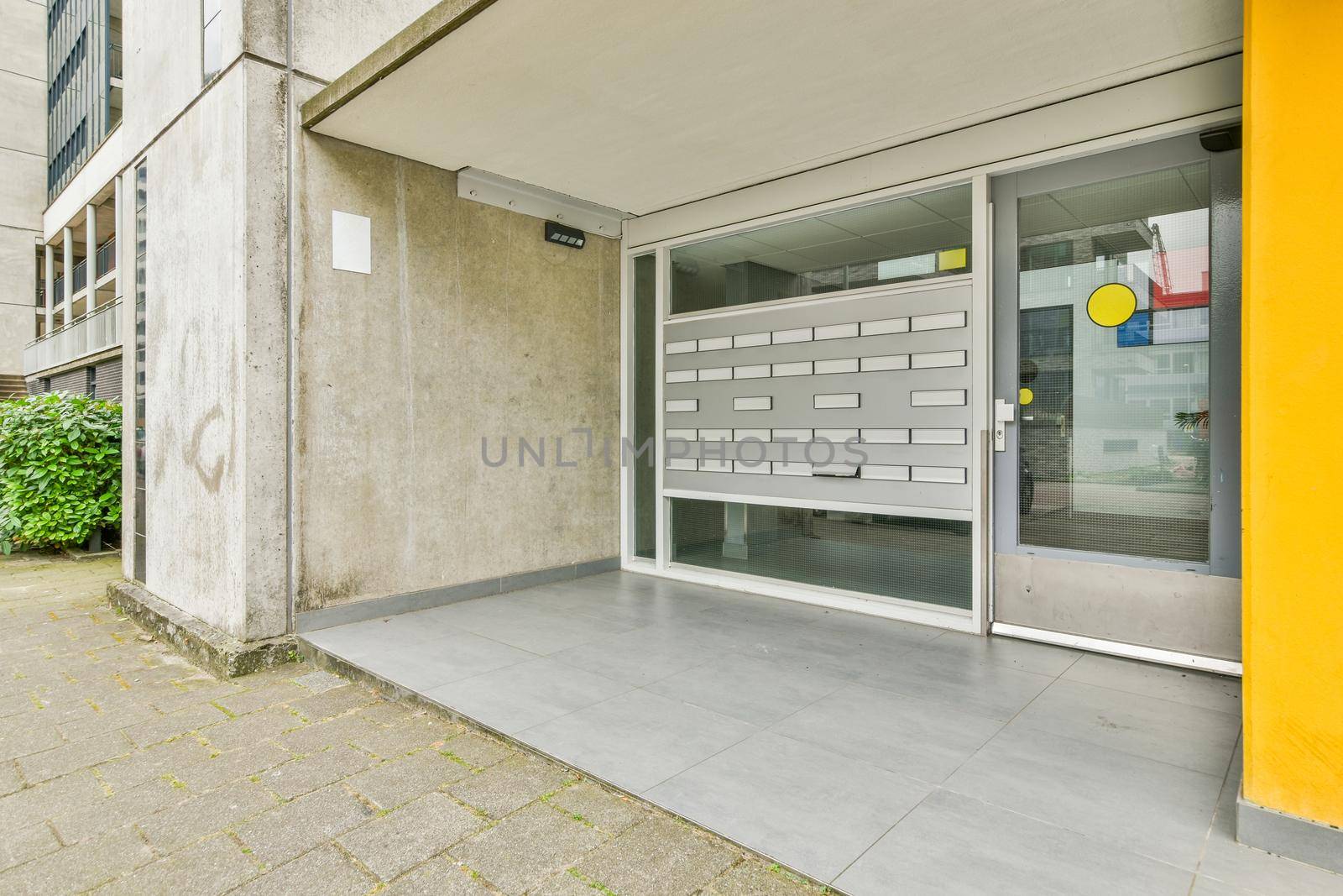 Residential building front door with white glass door