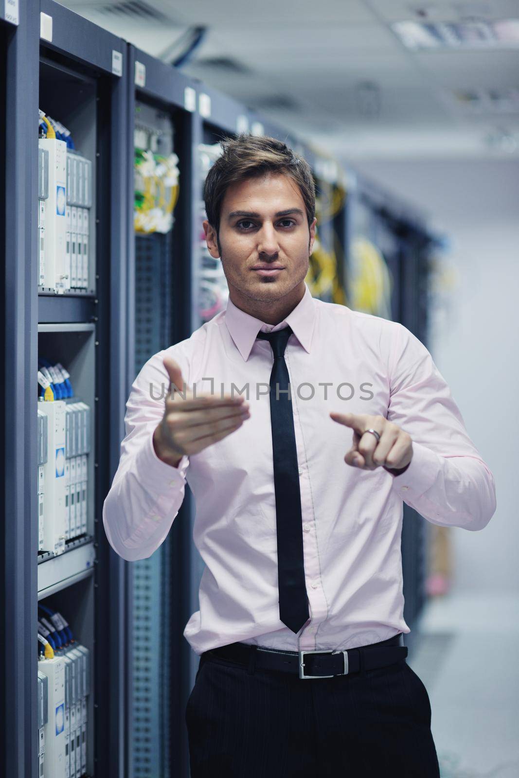 young handsome business man  engeneer in datacenter server room