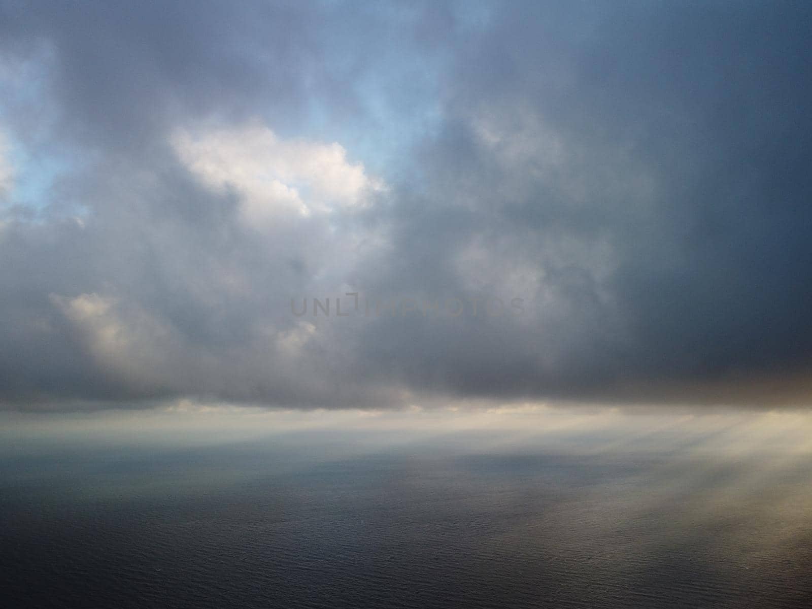 Abstract nature summer or spring ocean sea background. Small waves on water surface in motion blur with bokeh lights from sunrise.