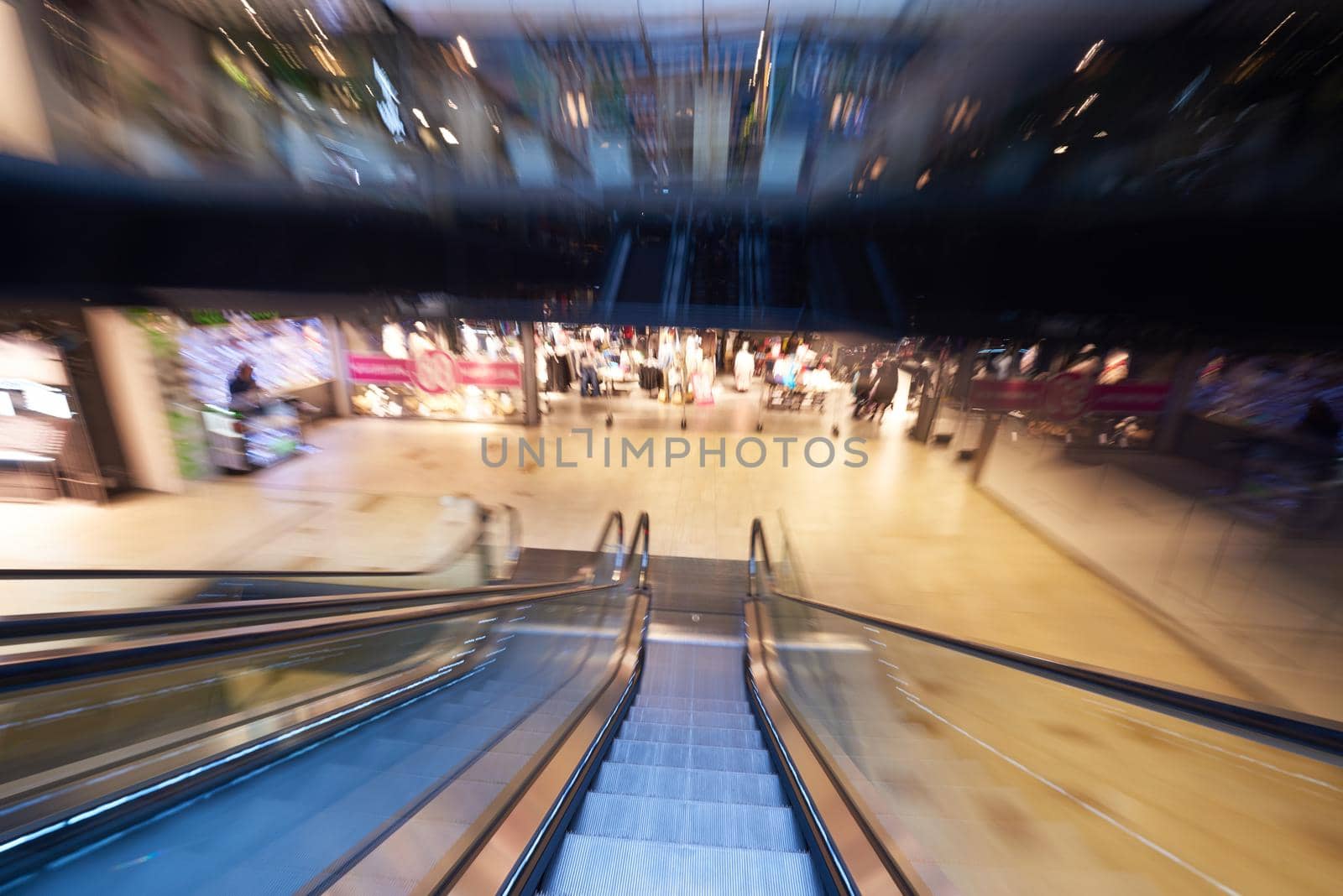 Shopping mall center escalators. Zoom blur movement.