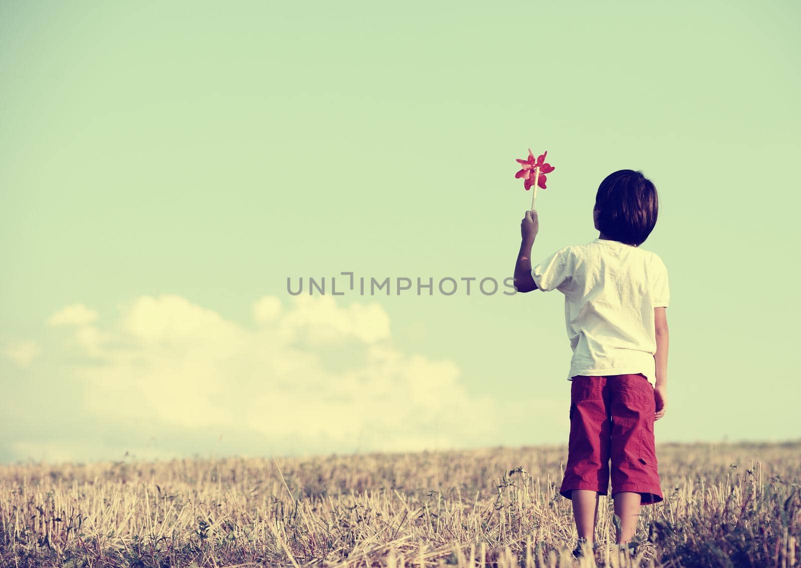 Kid standing in nature with large copy space by Zurijeta