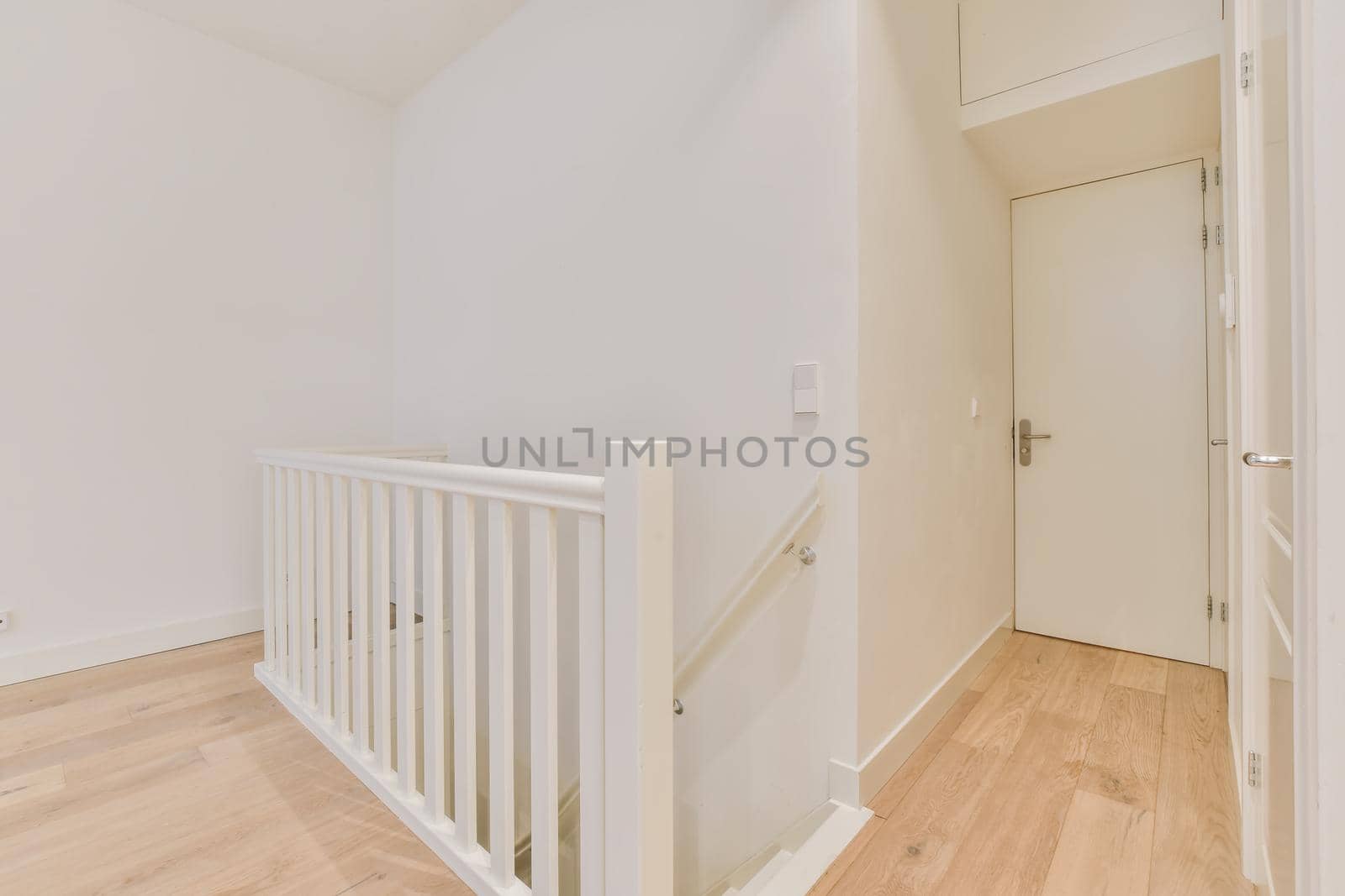 Luxurious bright room with parquet floor and staircase