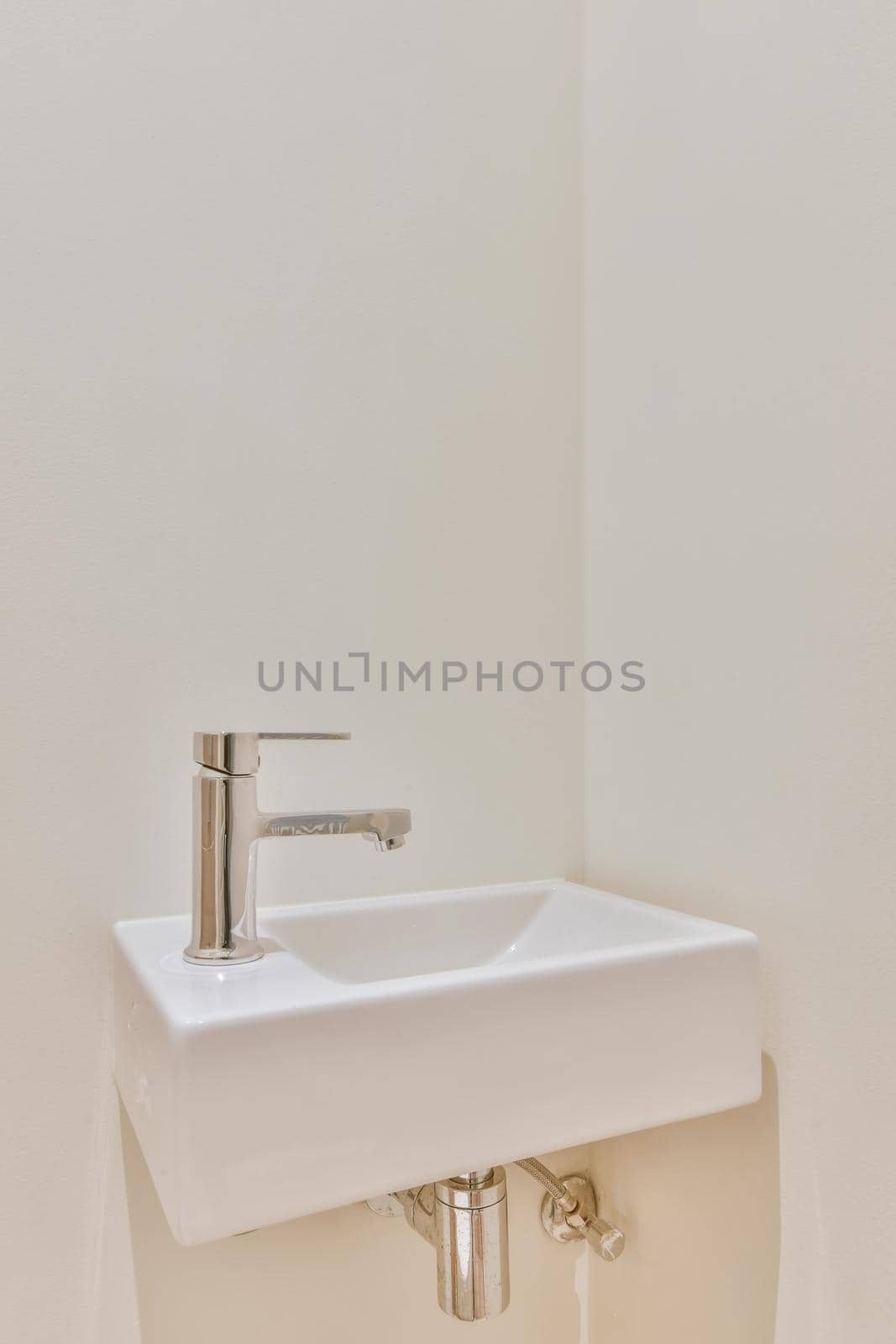 Luxurious washroom with beige tiled floor by casamedia