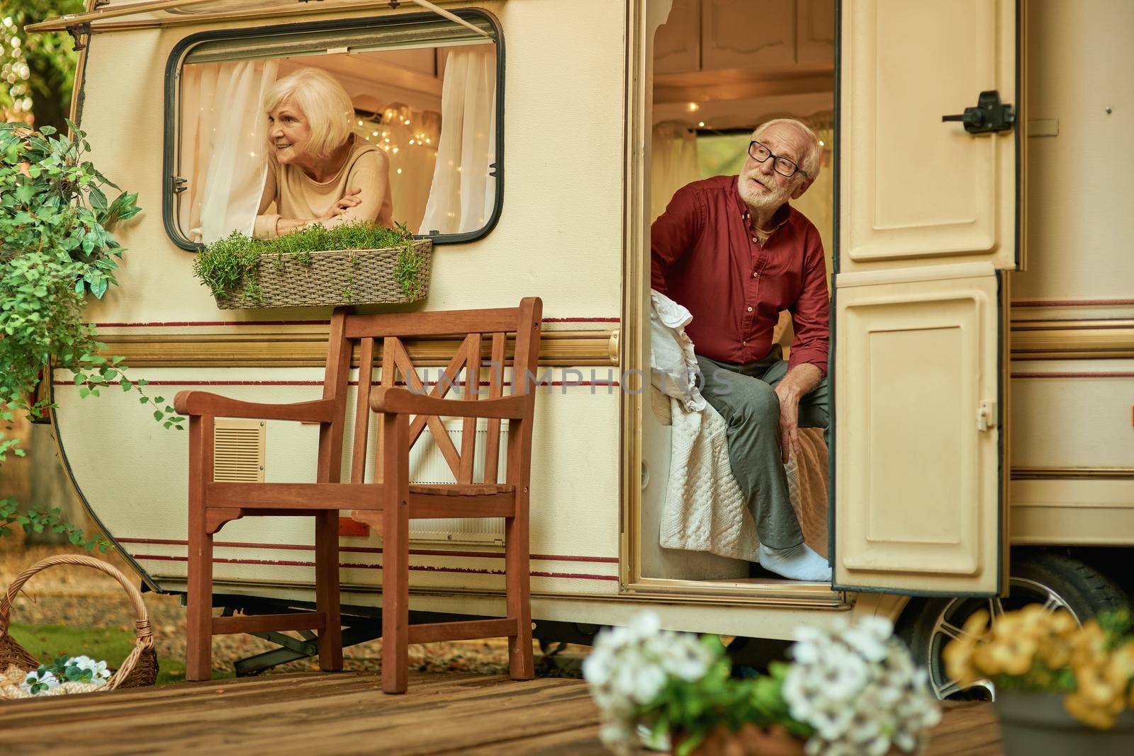 Happy elderly couple relaxing together in their traile by friendsstock
