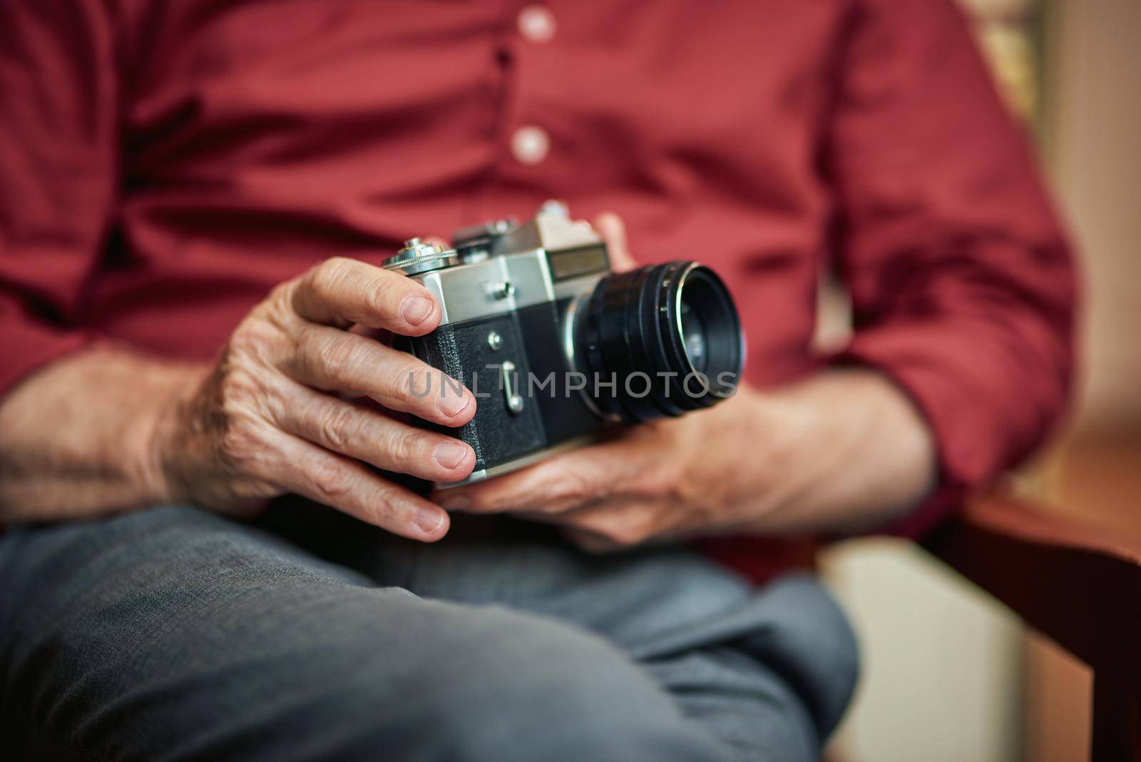 Cropped photo of male hands with rare camera by friendsstock