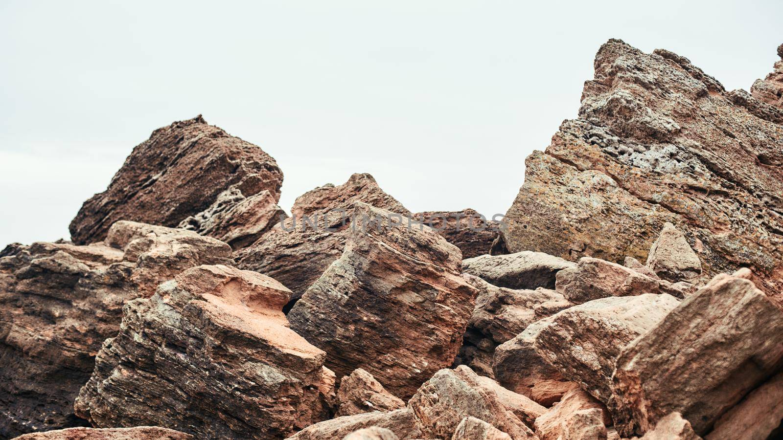 Big boulders on the beach. Nature landscape. Sky and rocks. Stone background