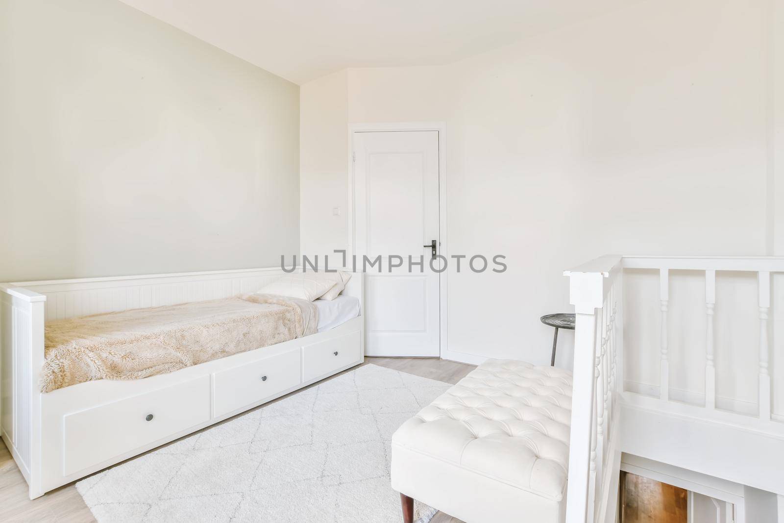 Adorable bright room in daylight with a snow-white ottoman