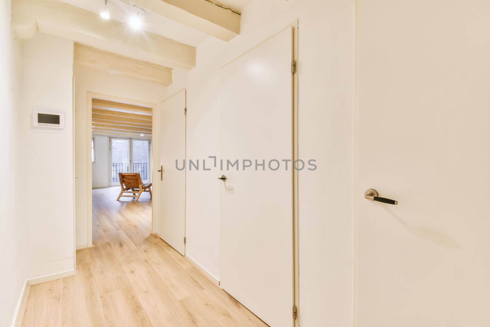 Luxurious bright corridor with many doors with parquet floor