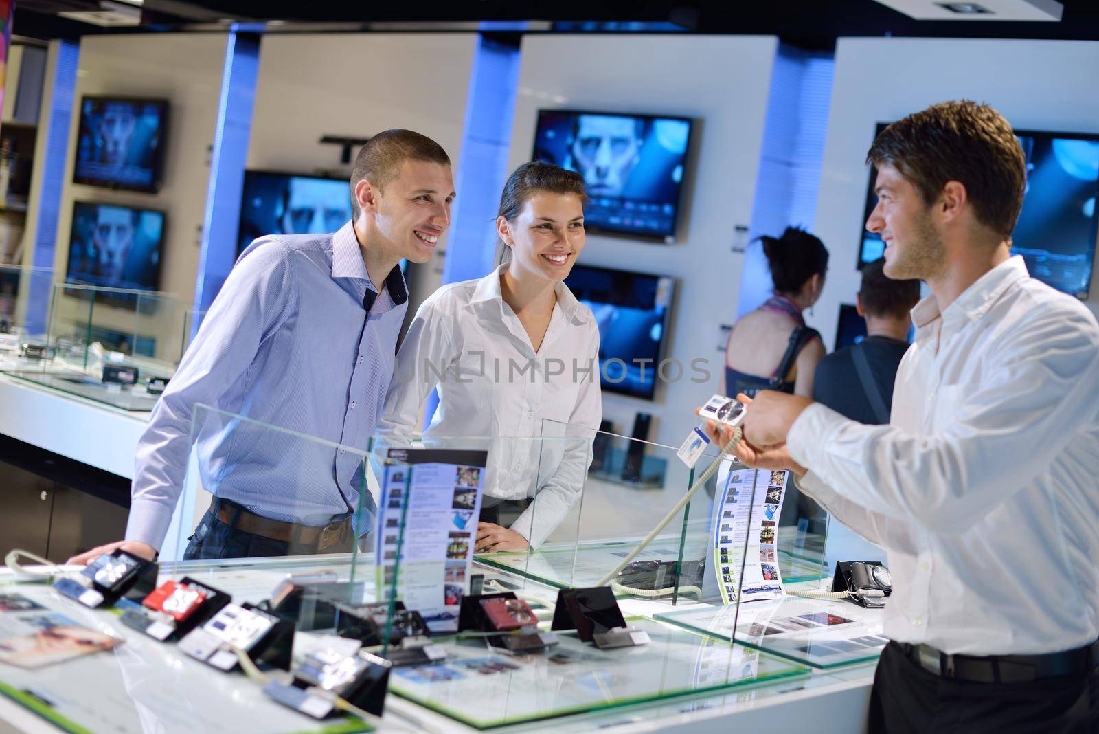 Young couple in consumer electronics store by dotshock