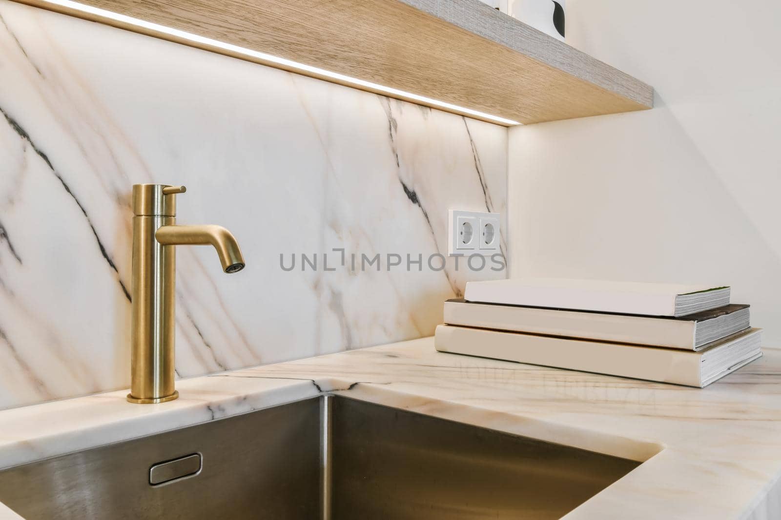 Stunning modern sink with faucet and books in the background