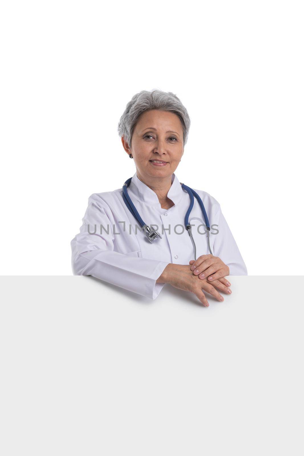 Mature asian female doctor holding blank banner isolated on white background