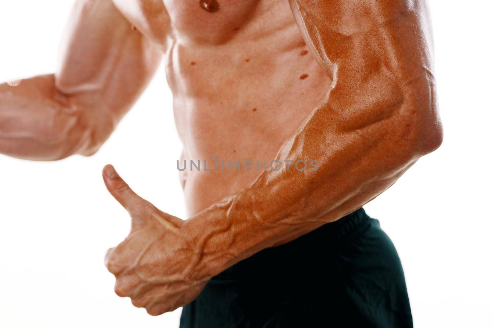 man with a pumped up body muscle closeup workout bodybuilders. High quality photo