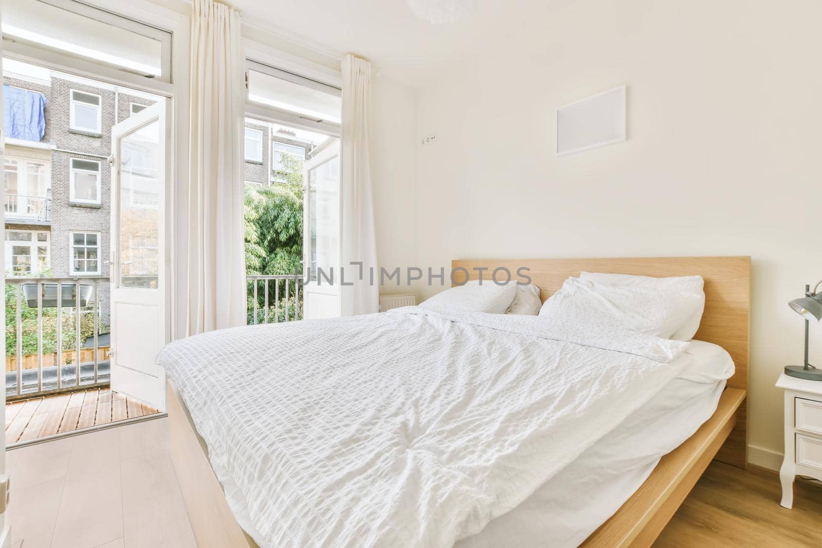 Adorable bedroom with white fluffy bedspread and white bedside table