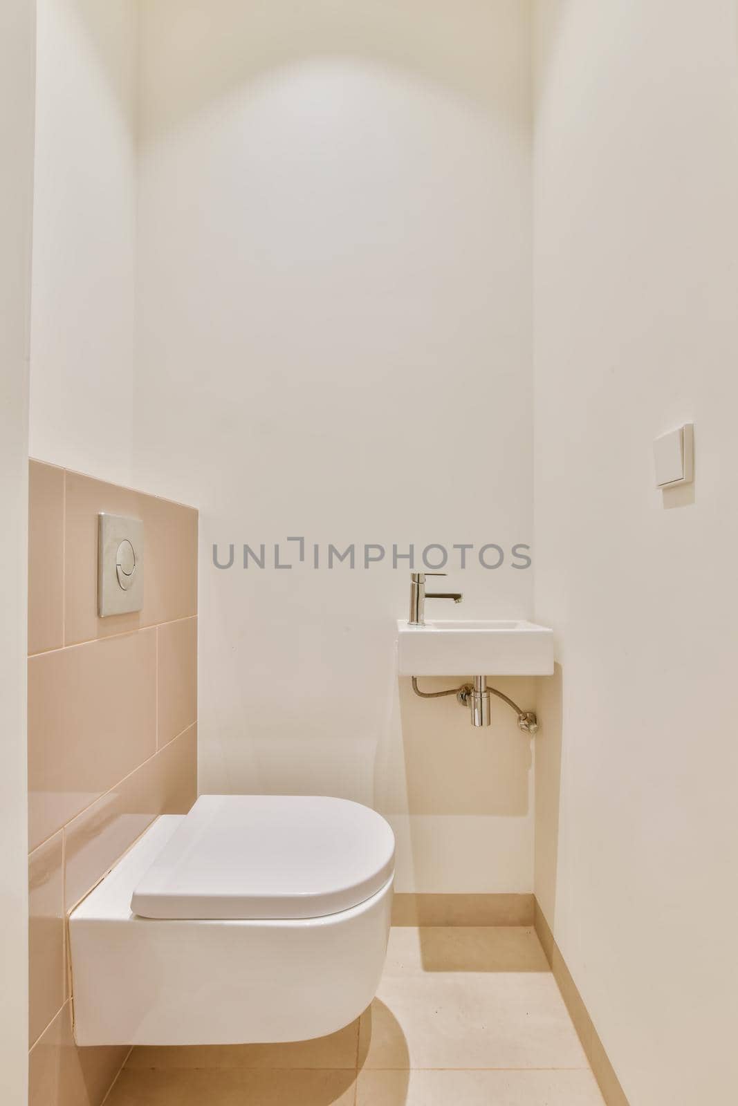 Luxurious washroom with beige tiled floor and miniature washbasin