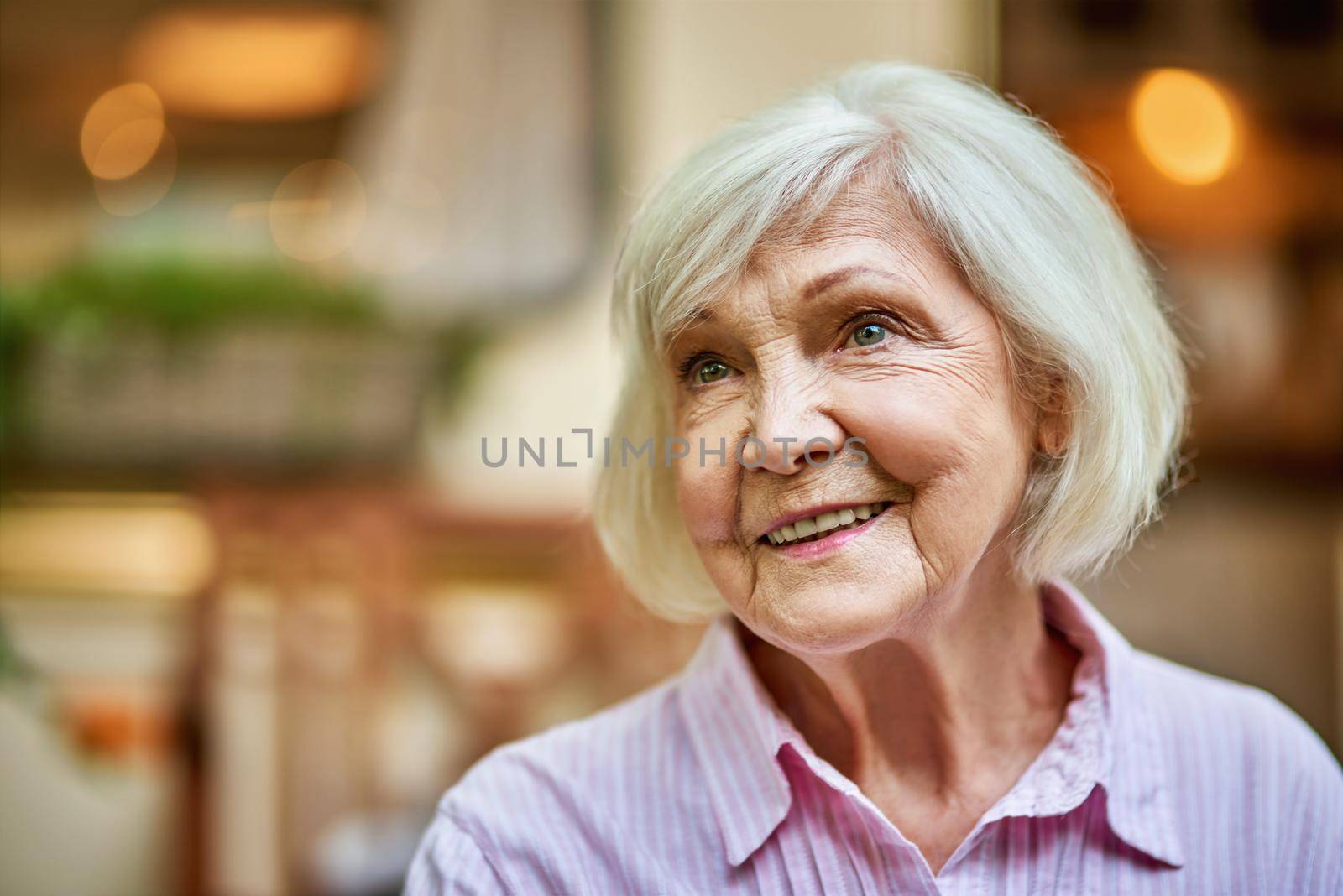 Happy attractive senior lady enjoying her life by friendsstock