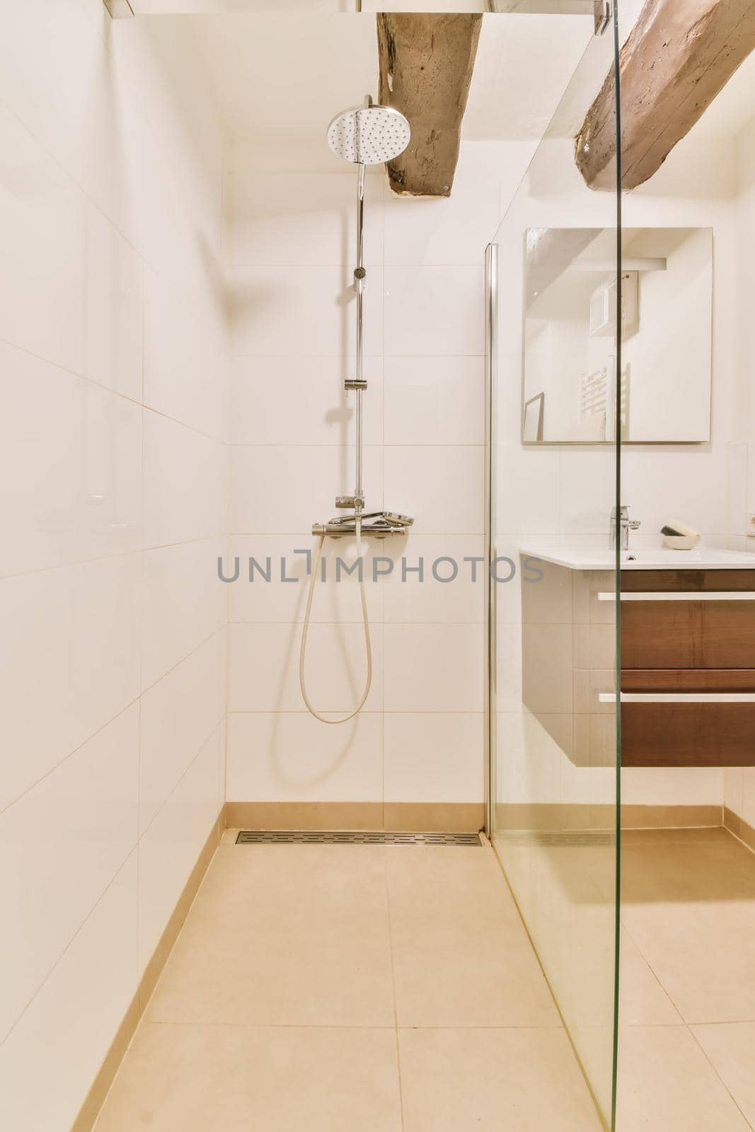 Luxurious shower cubicle with glass partition and modern tap