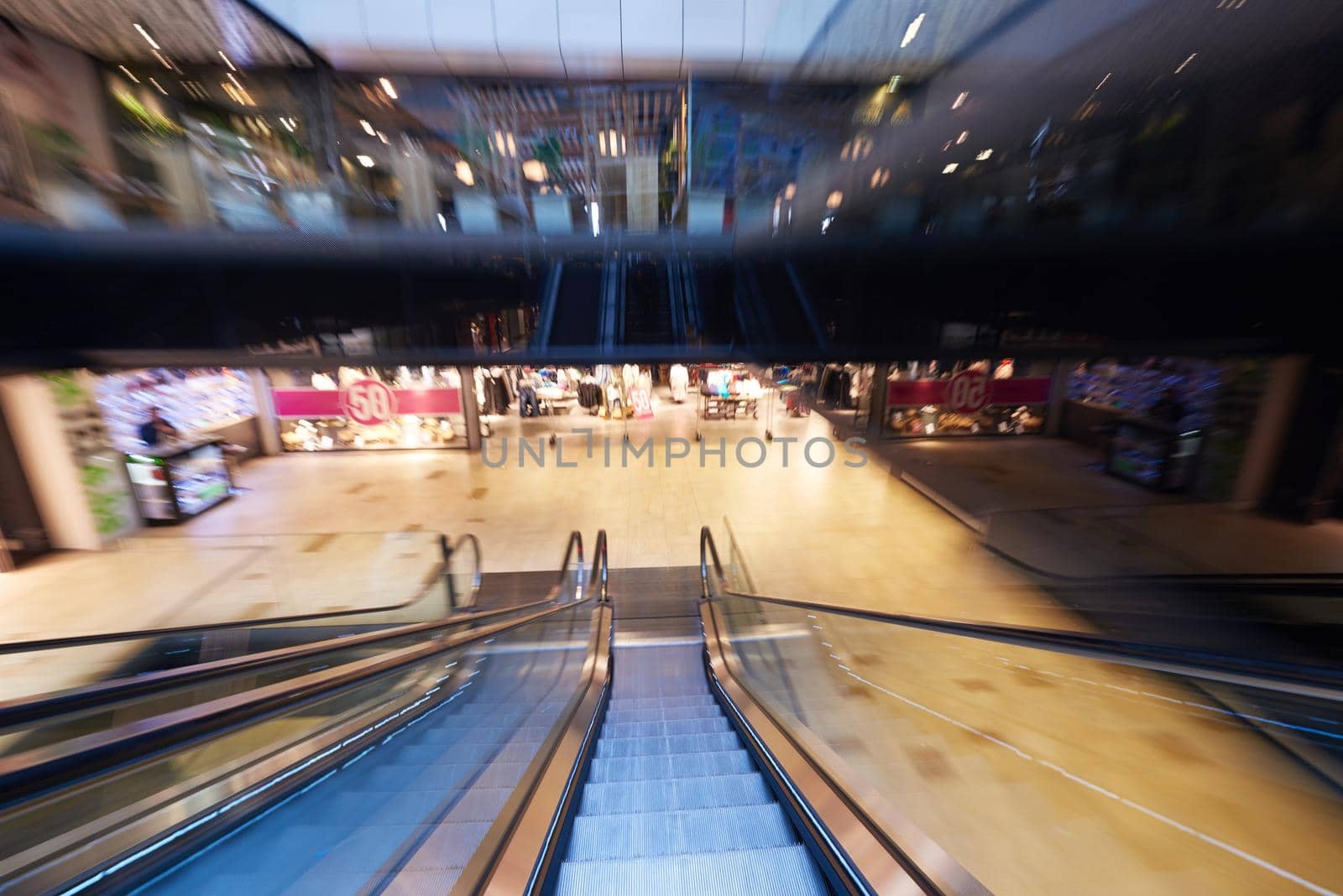 Shopping mall center escalators. Zoom blur movement.