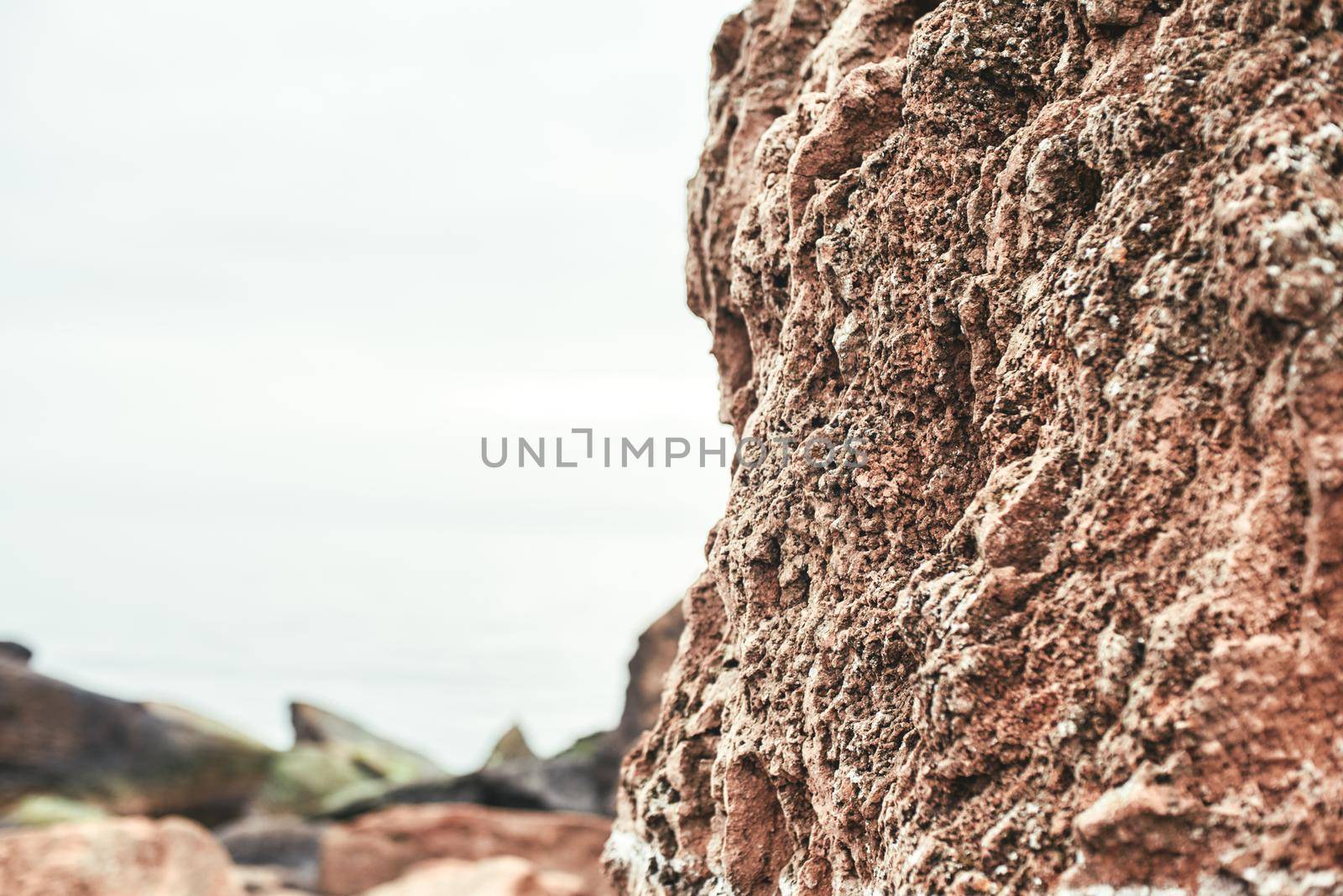 Close up photo of old stone brown wall on the beach. Nature landscape