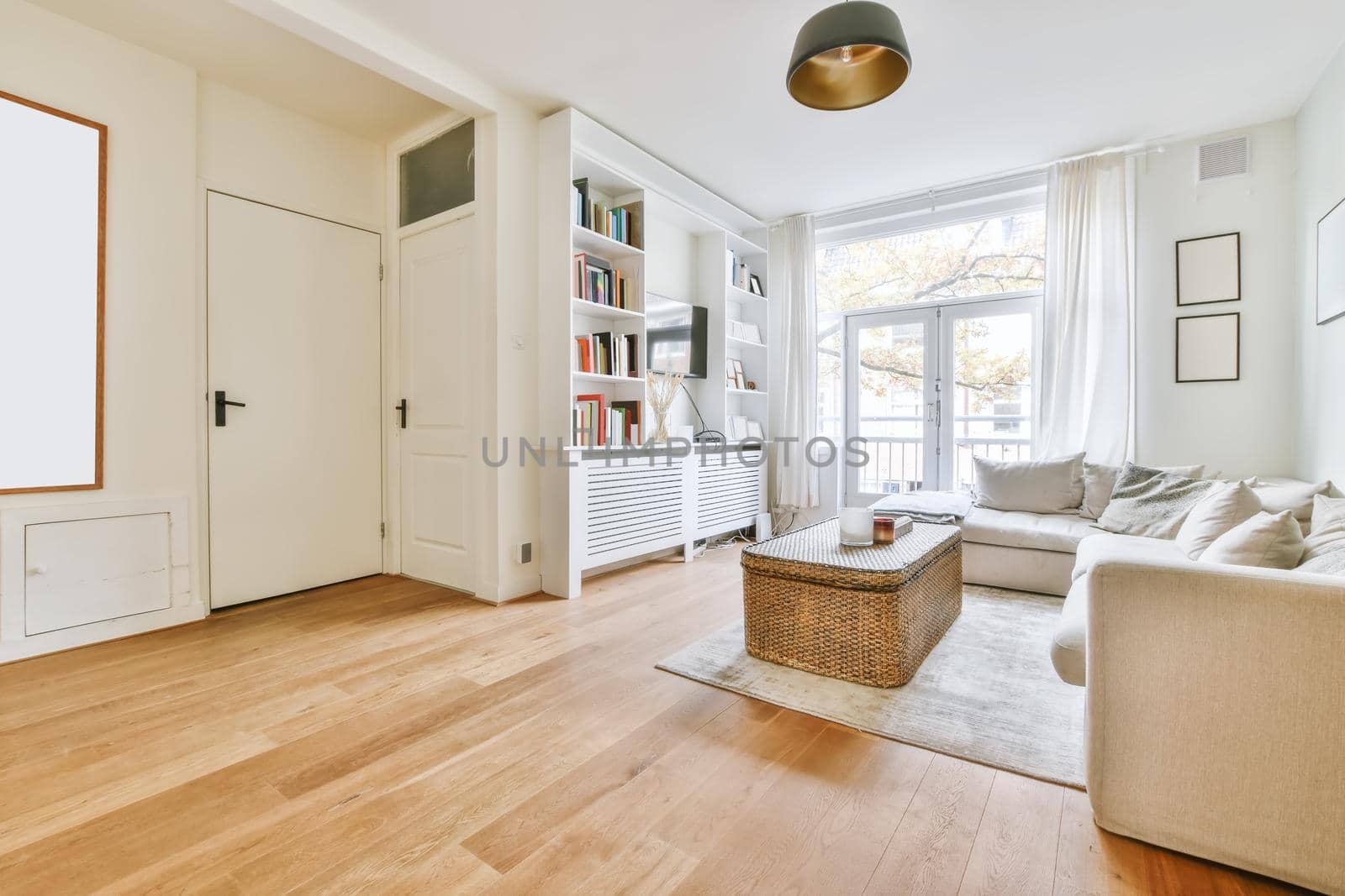 Adorable living room with large soft sofa and wicker coffee table