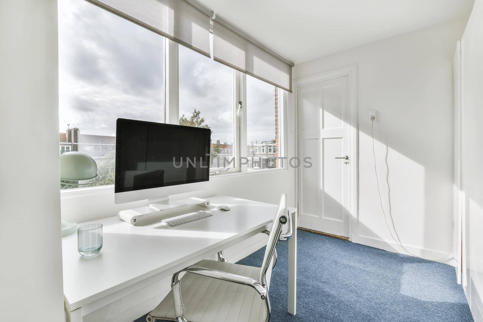 Bright work room with white long work table