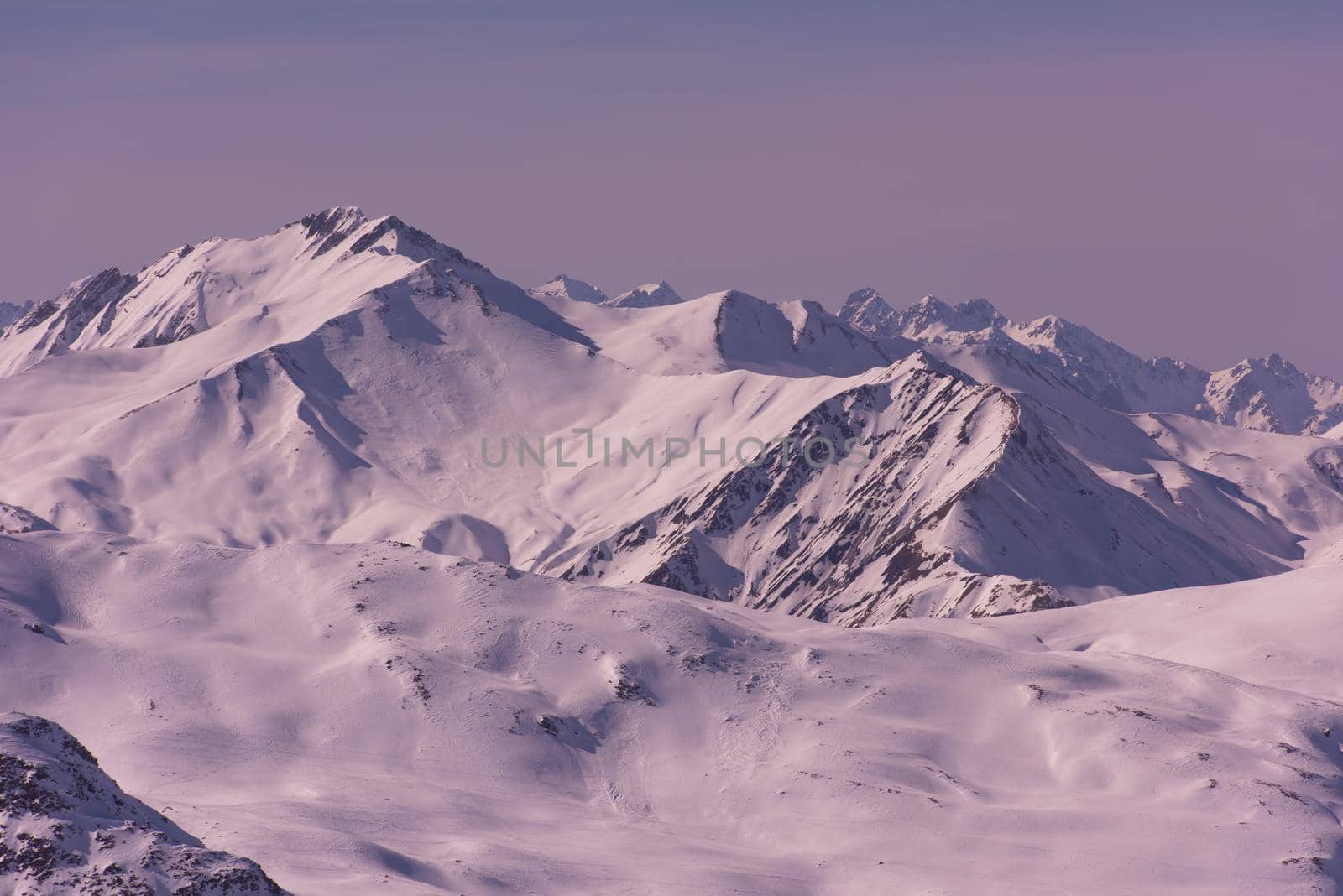 mountain landscape at winter with fresh snow on beautiful sunny day at french alps