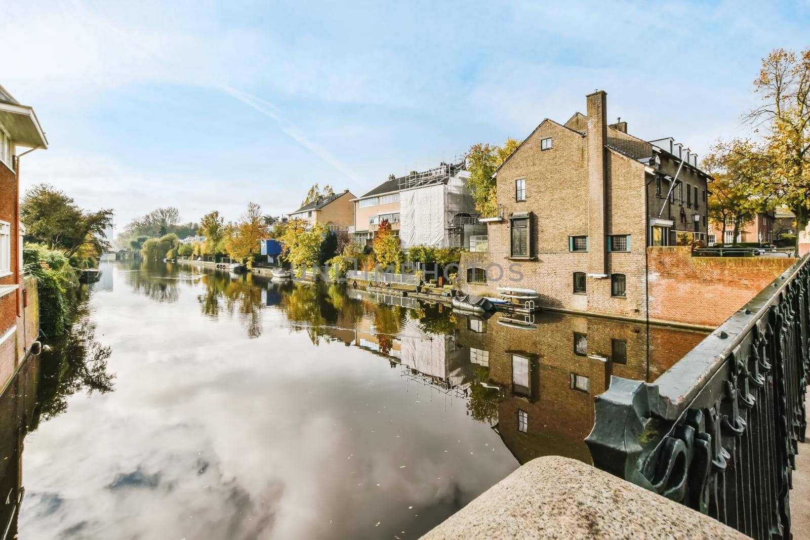 Adorable view of the canal with lots of greenery and boats