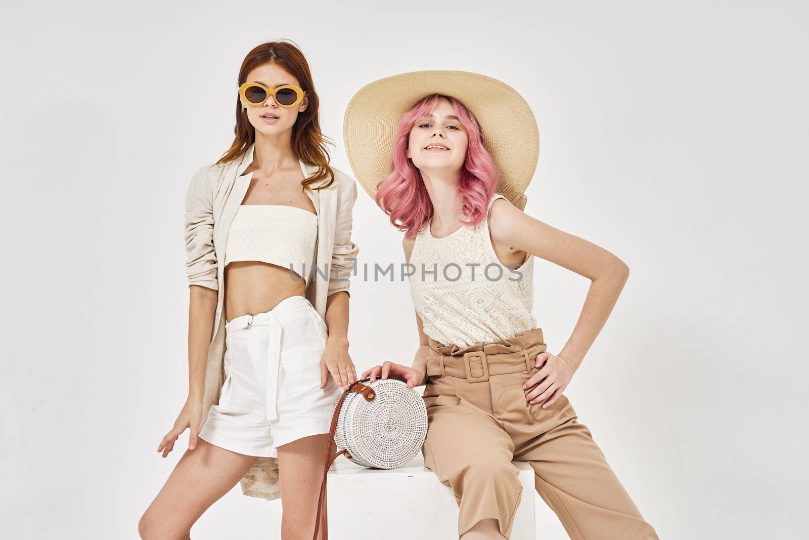 two girlfriends stand side by side fashion clothing glamor posing by Vichizh