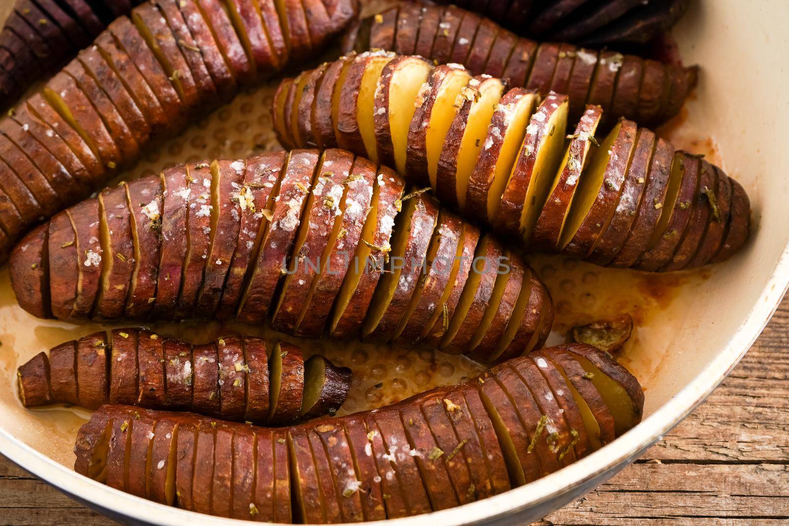 Sweet potato - sweet potato tubers cooked in a pan. Fried and baked with spices and salt. Cut into pieces and slices. Healthy food close-up top view. by A_Gree