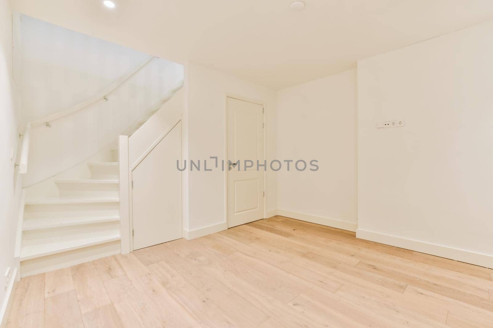 Luxurious bright room with parquet floor and staircase