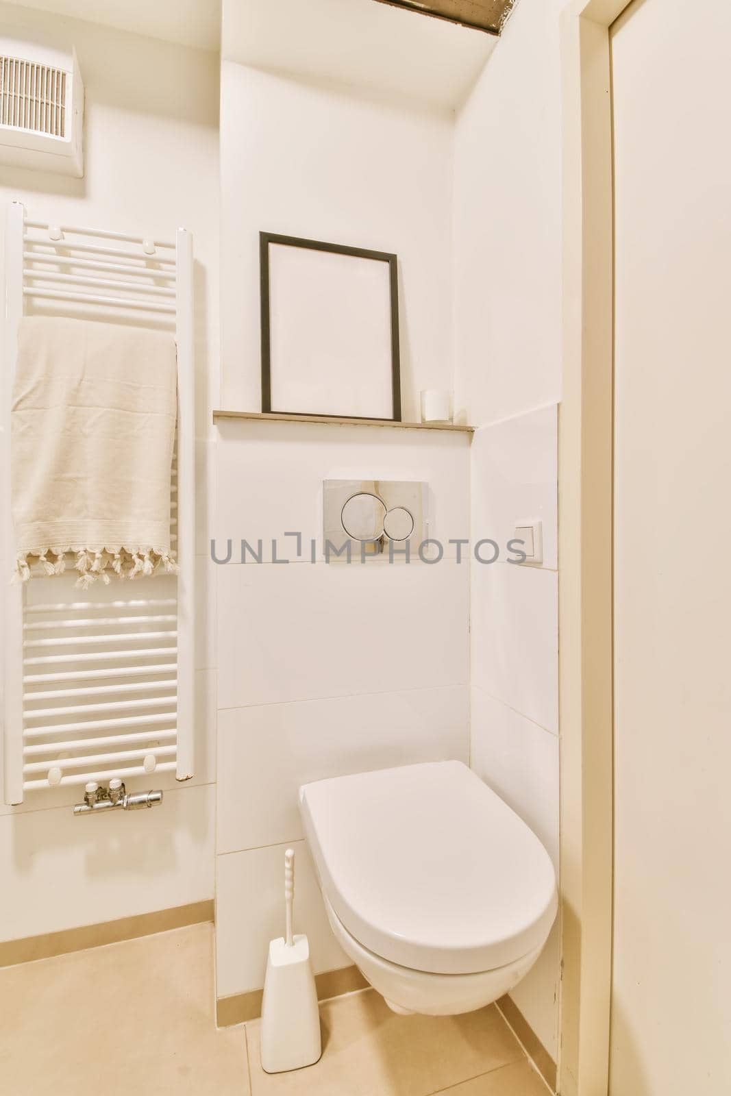 Luxurious restroom with hanging toilet and portrait on the shelf