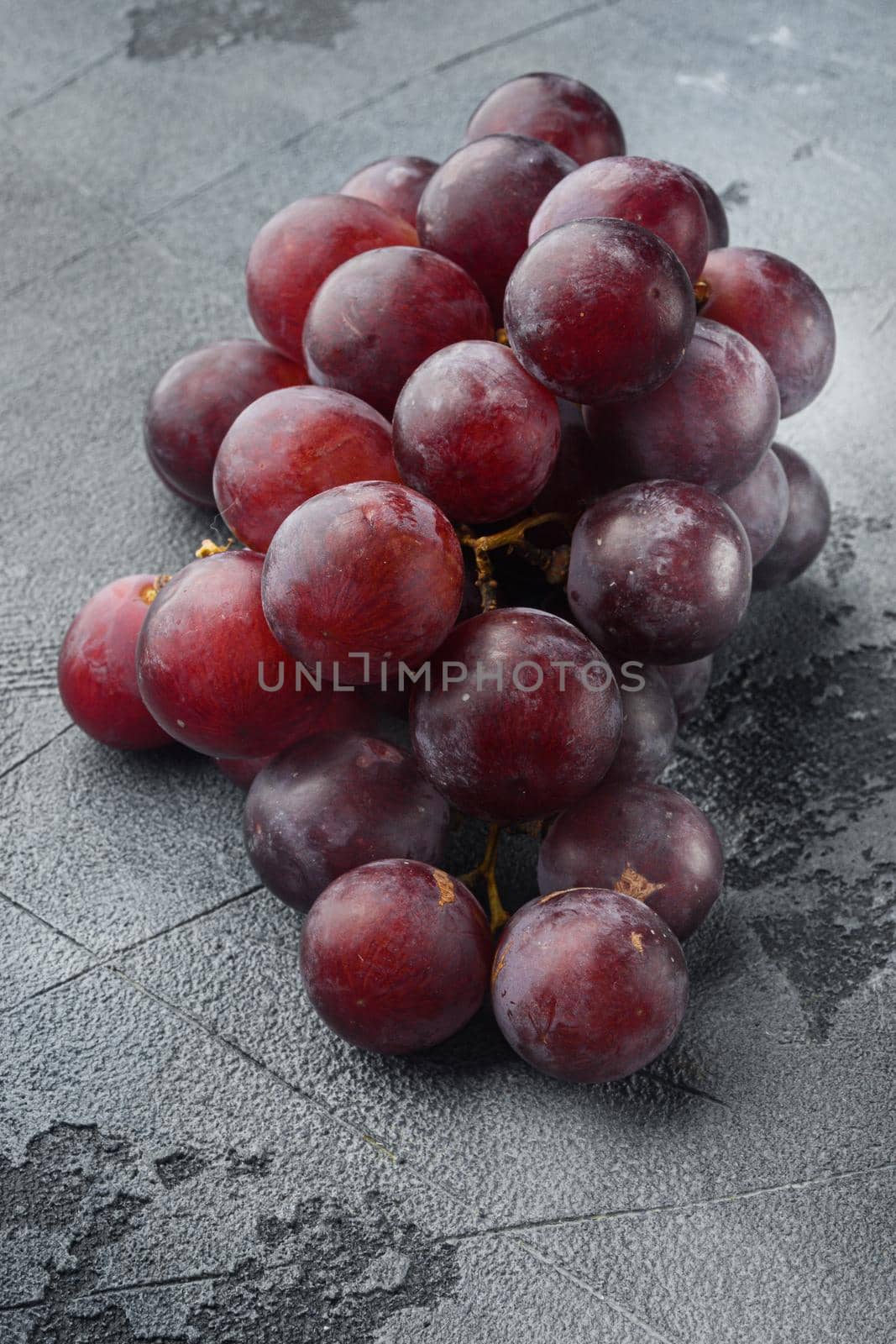 Red and white grapes set, dark red fruits, on gray stone background