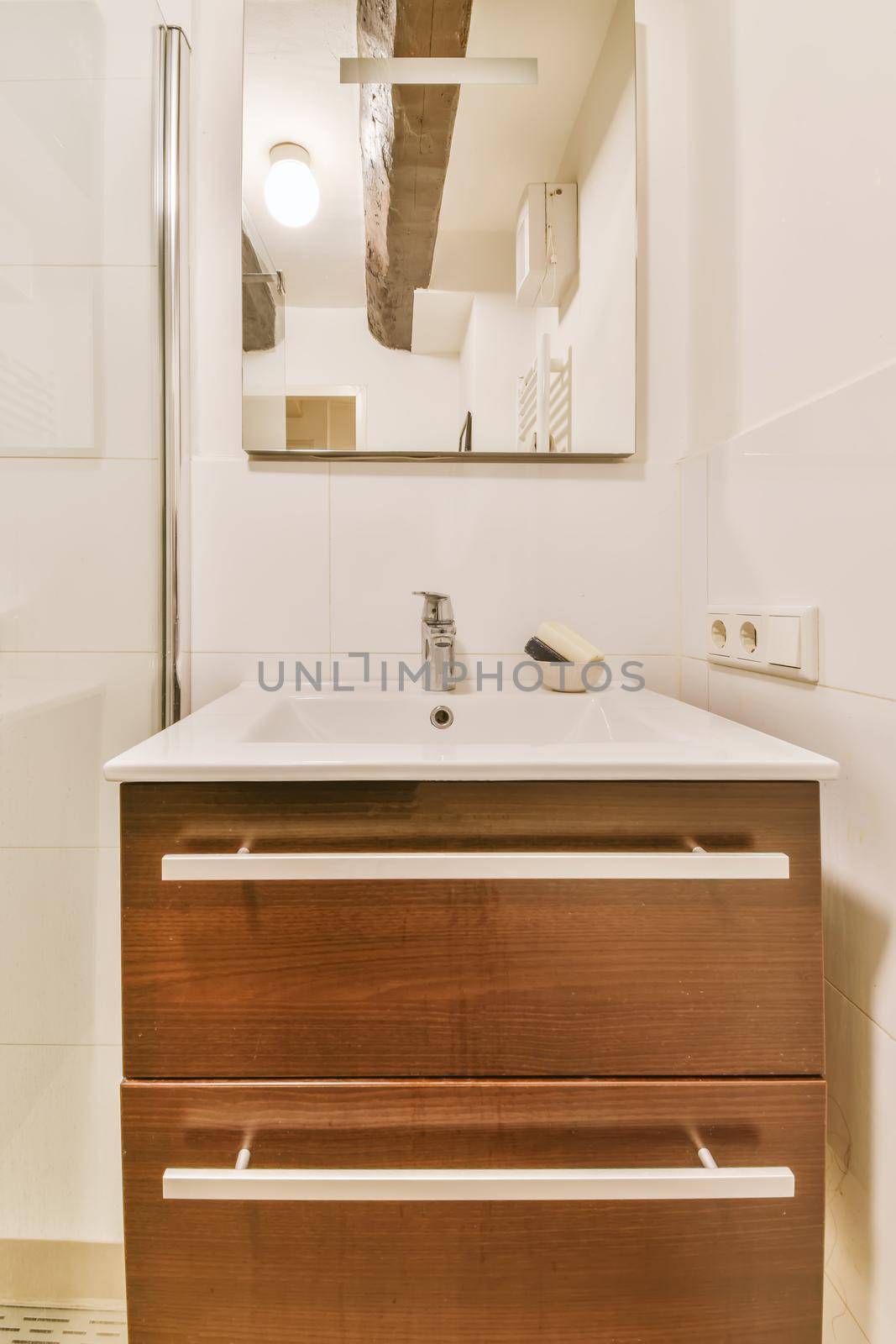 Chic sink with wooden chest of drawers and mirror
