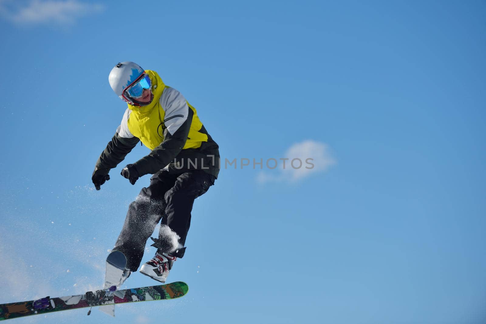 jumping skier at mountain winter snow fresh suny day