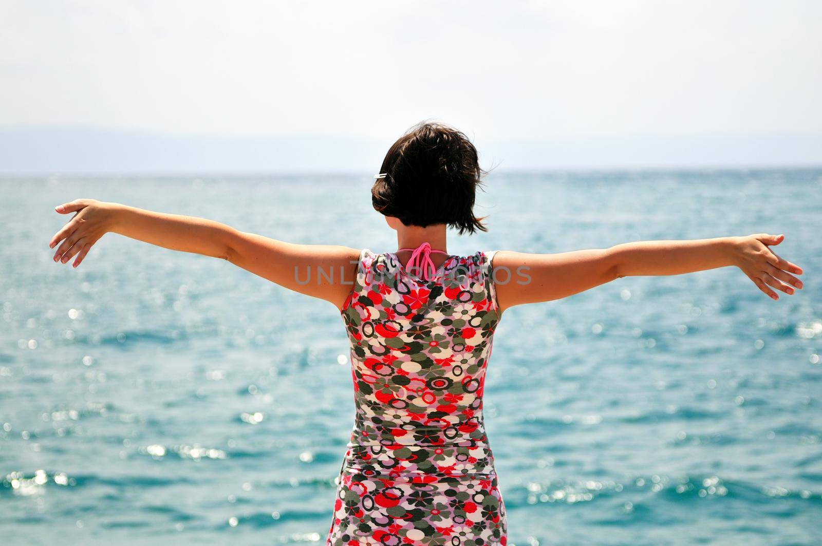 Young pretty woman enjoying the sun and the sea