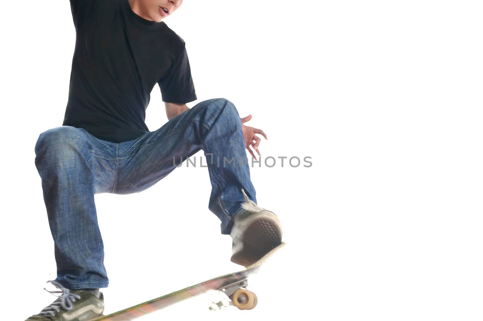 Boy practicing skate in a skate park - isolated