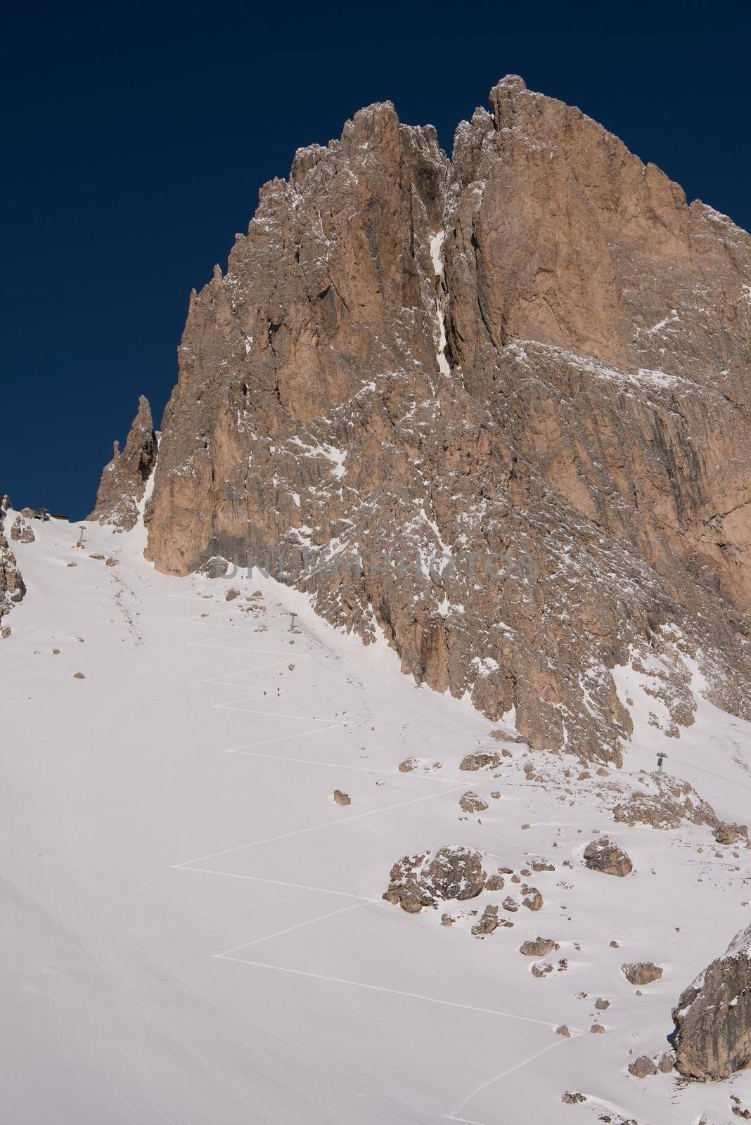 hiking touring ski tracks in snow climbing to mountain top at beautiful winter day with fresh snow