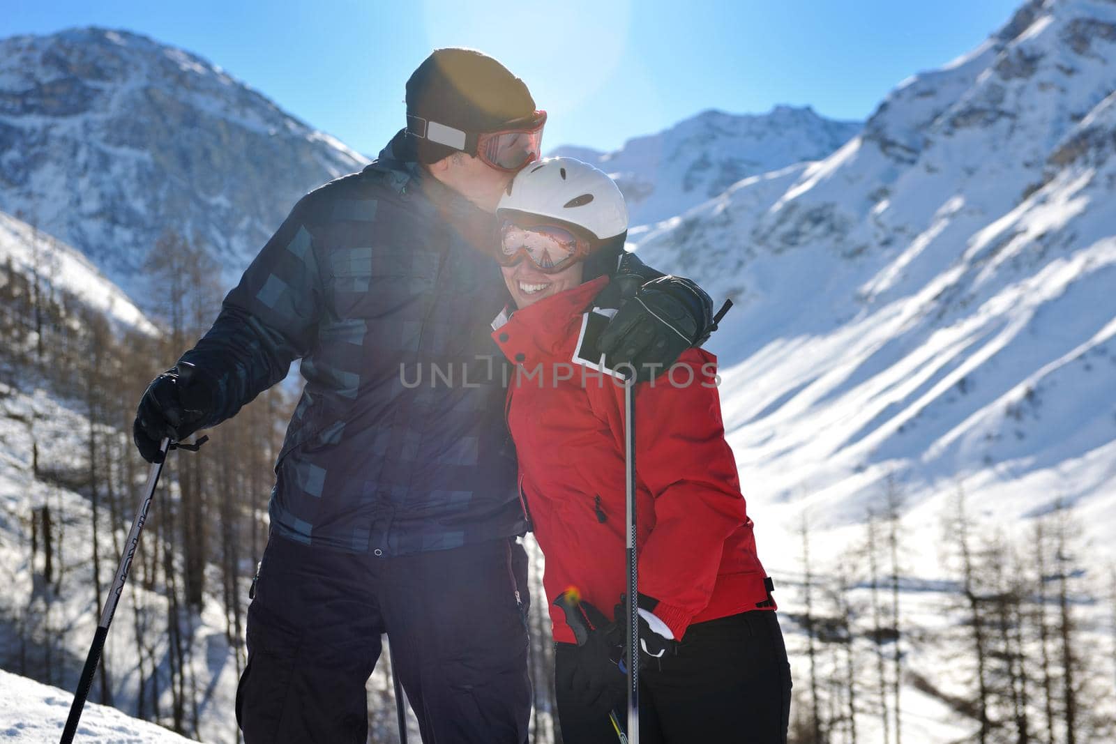 happy people group have fun on snow at winter season on mountain with blue sky and fresh air