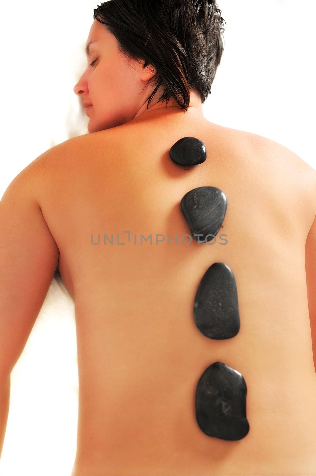 beautiful woman have hotstone massage at spa and wellness center