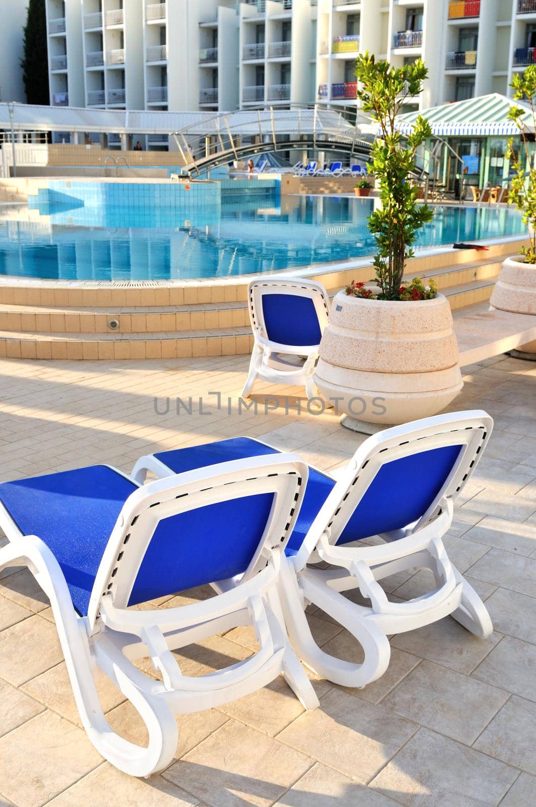 Empty chairs by the pool of luxery hotel