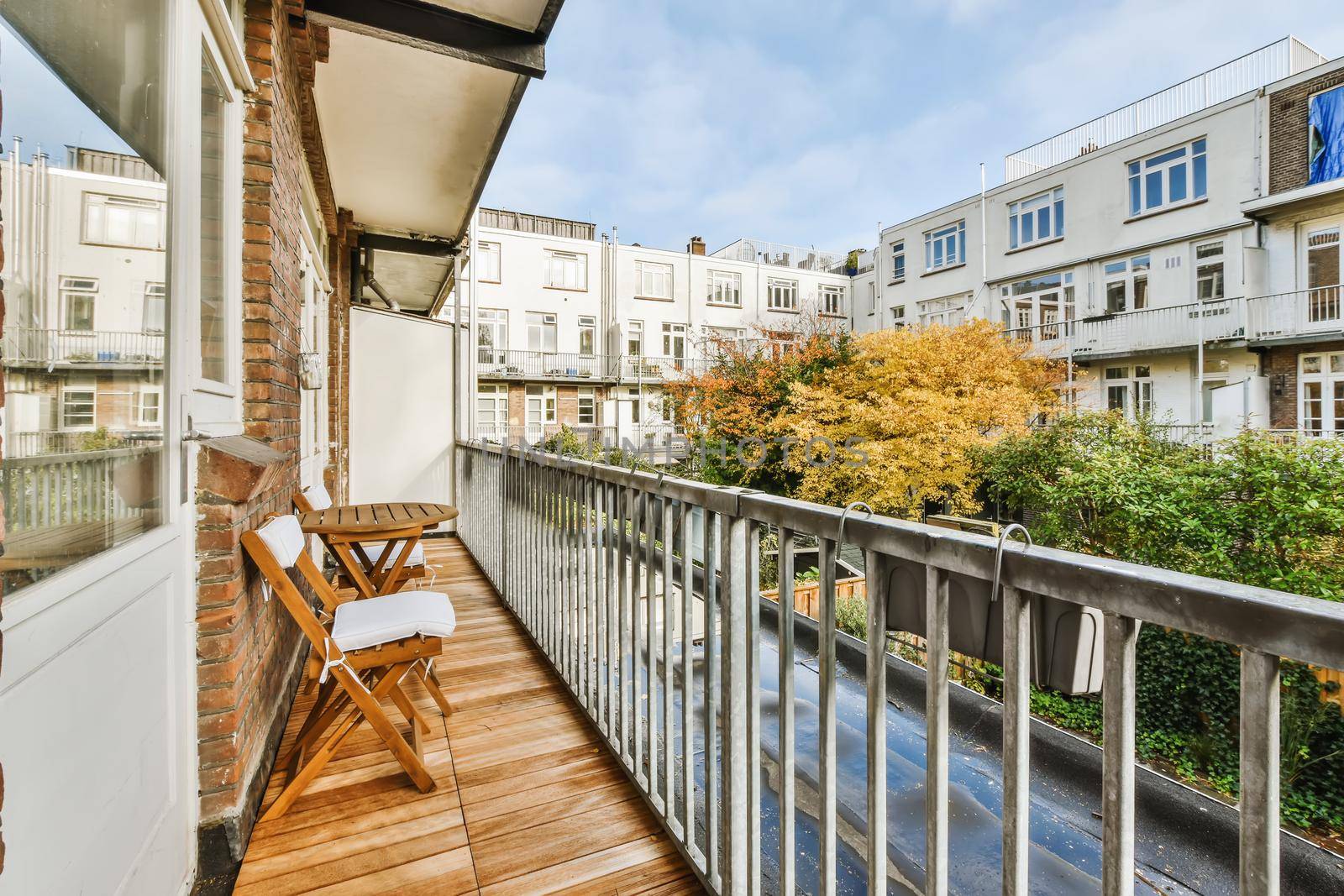 Lovely balcony with iron railings and wooden floor