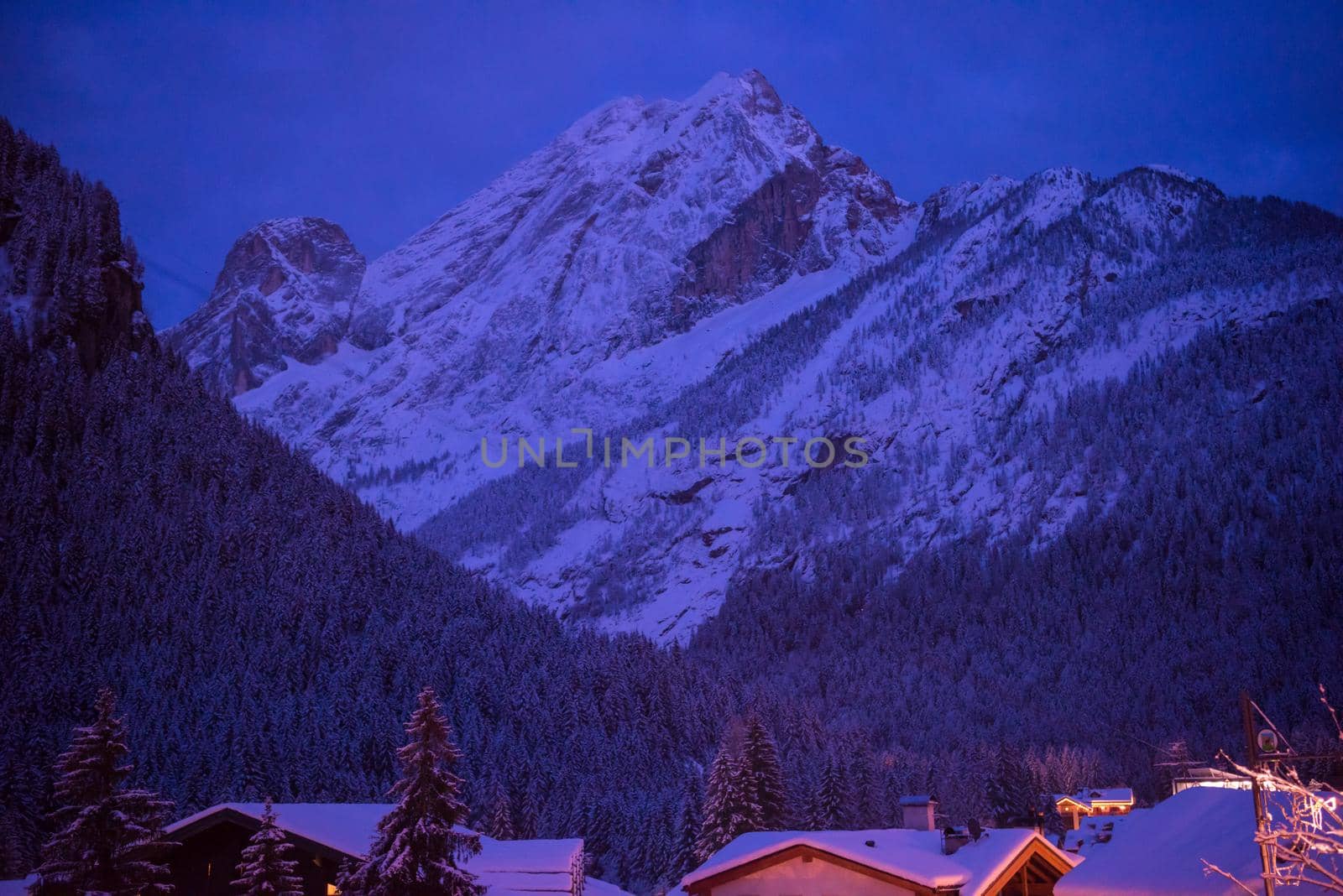 mountain village in alps  at night in winte  with fresh snow