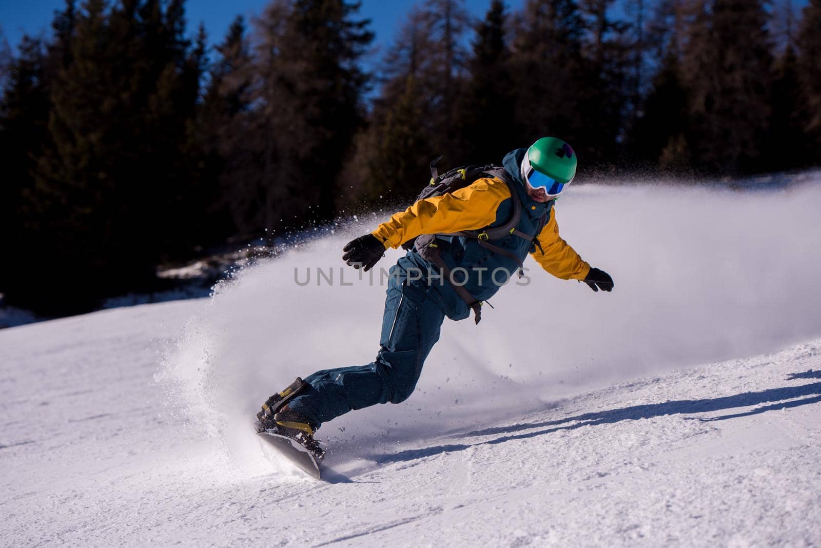 snowboarder running down the slope and ride free style by dotshock
