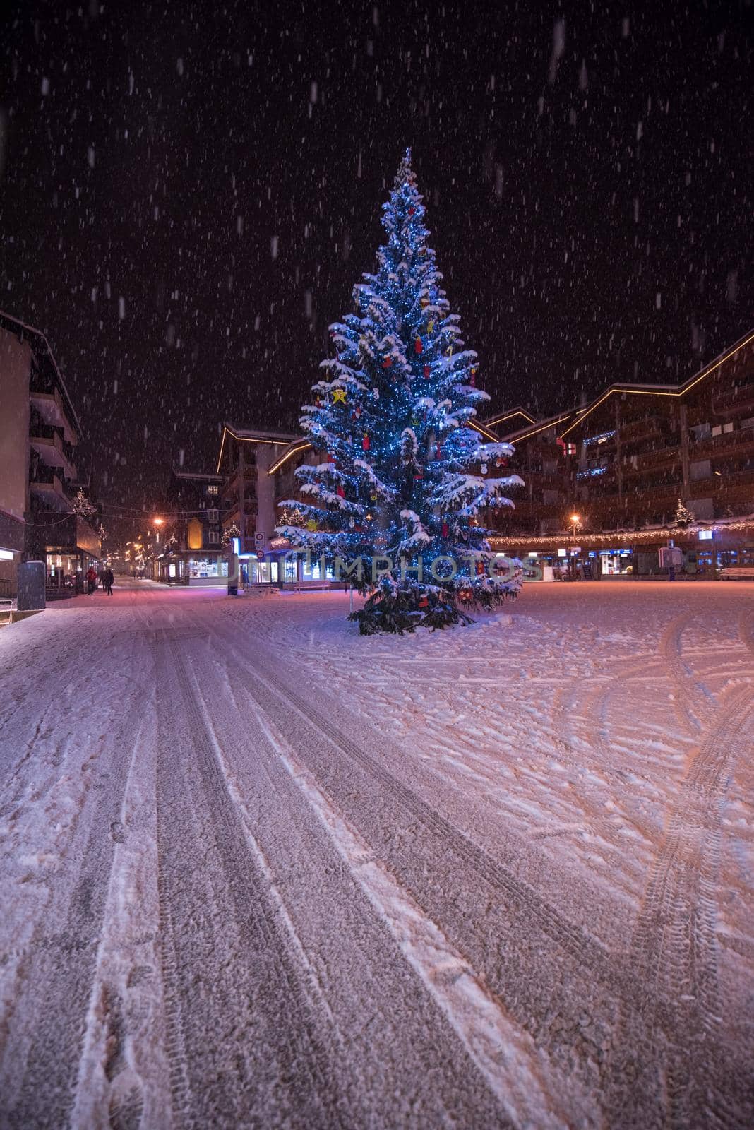 a view on snowy streets of the Alpine mountain village in the cold winter night