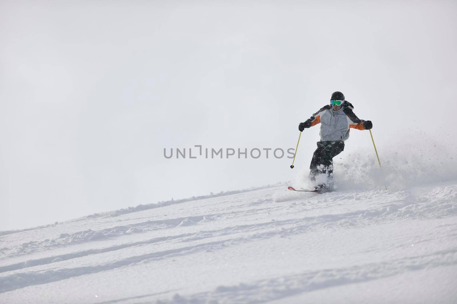 man ski free ride downhill at winter season on beautiful sunny day and powder snow