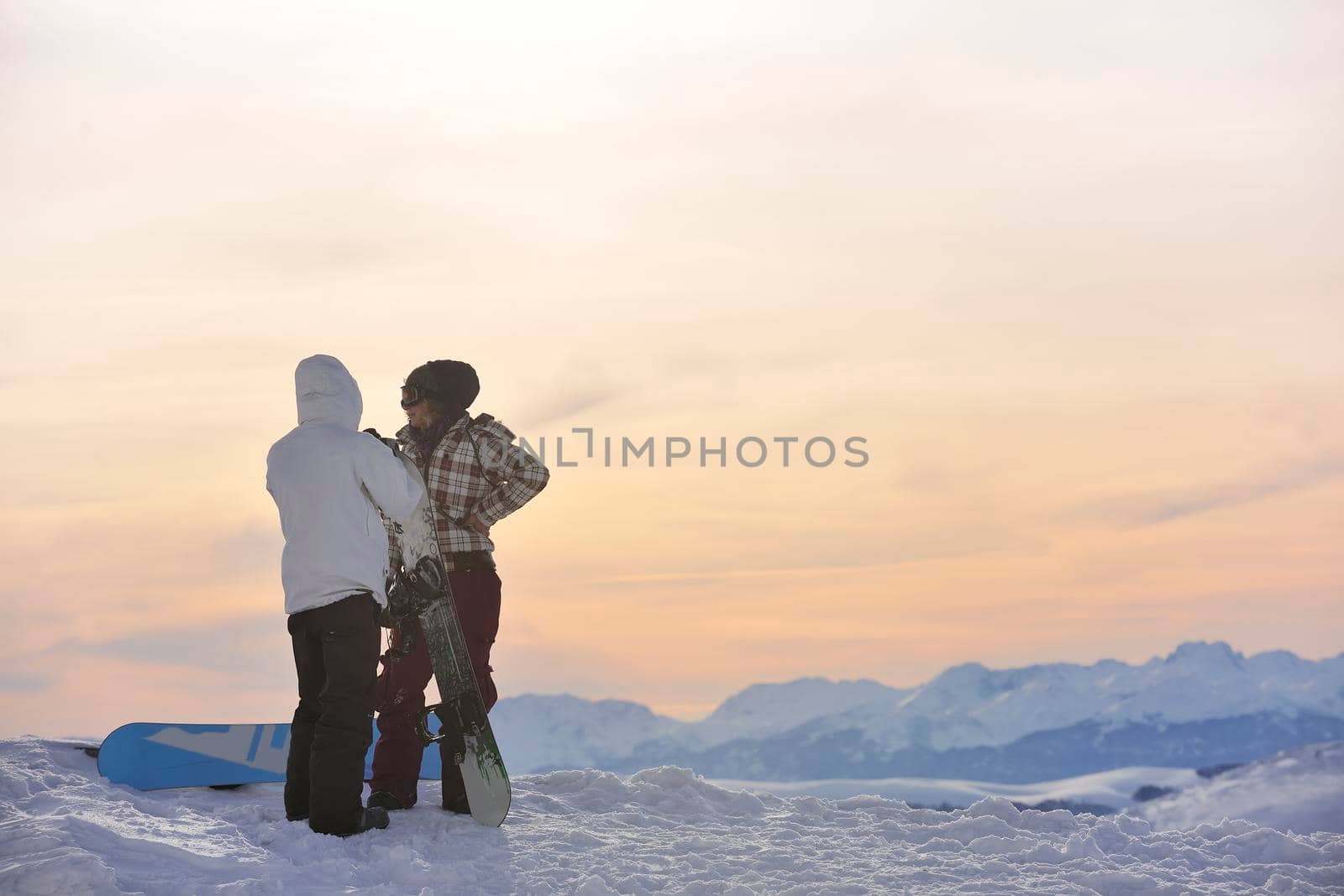 snowboarder's couple on mountain's top by dotshock