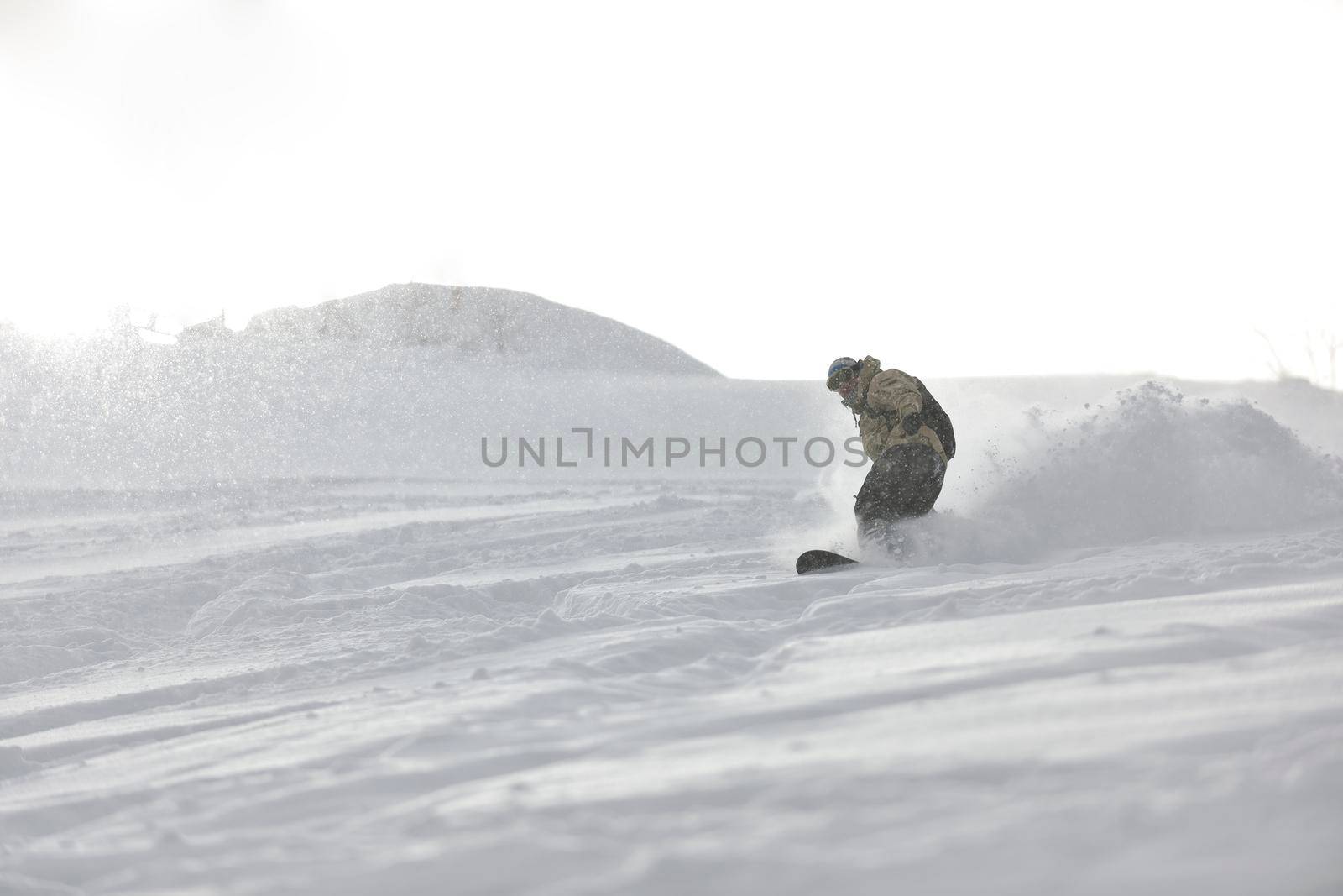 freestyle snowboarder jump and ride free style  at sunny winter day on mountain