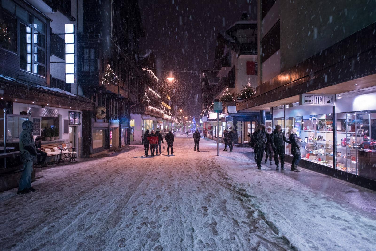 a view on snowy streets of the Alpine mountain village in the cold winter night